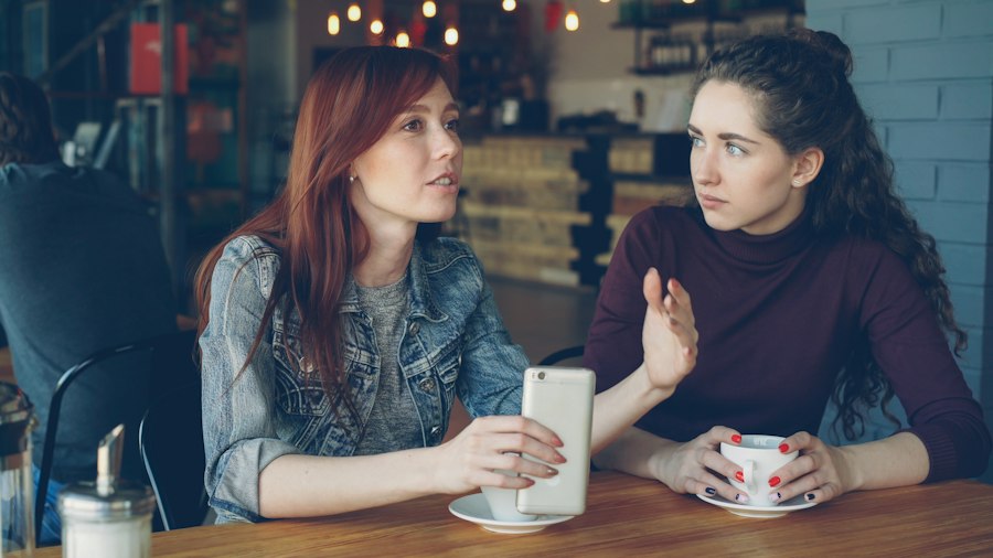 Two women deep in conversation at a café