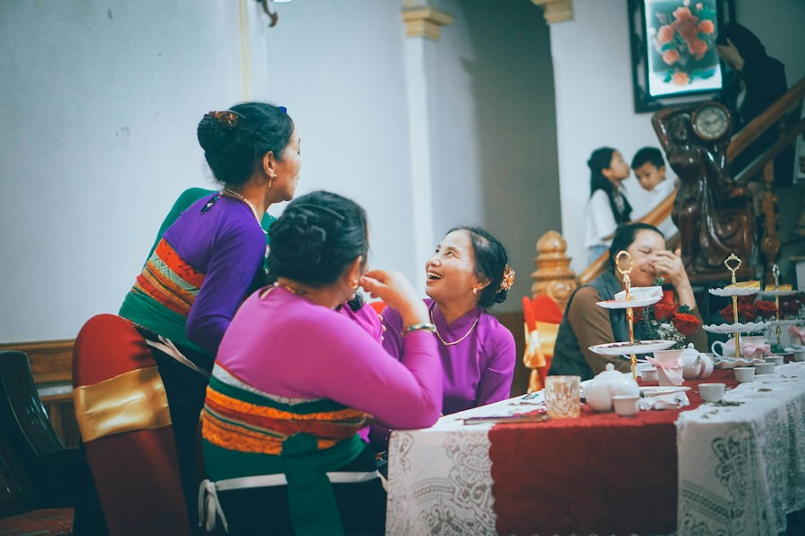 Women in colourful traditional clothing talking around a table