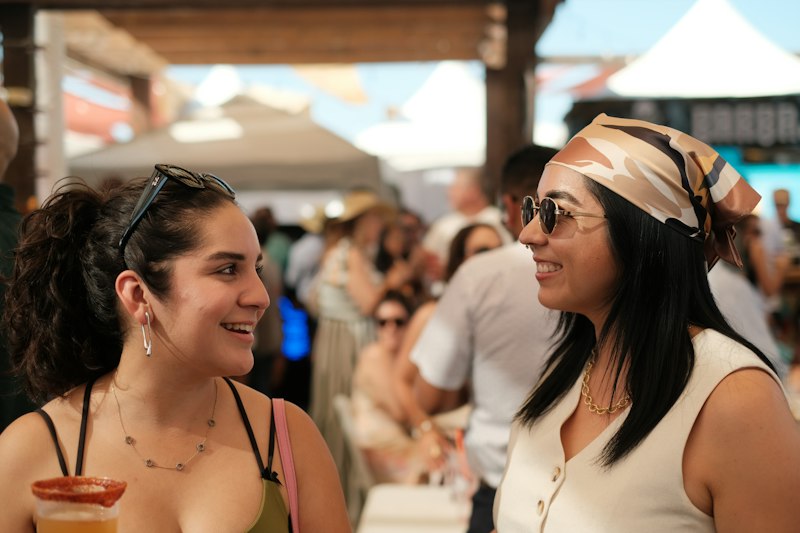 Two women chatting at an outdoor festival