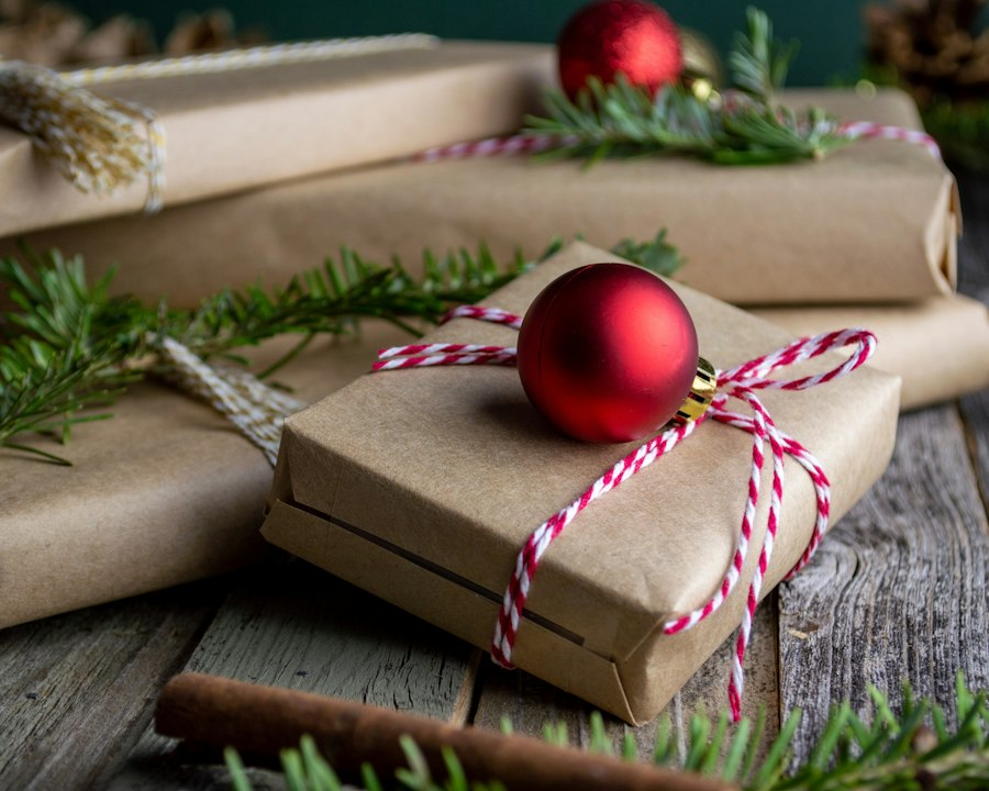 Gifts wrapped in brown paper with a red bauble